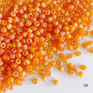 Macro detail of 4mm matte orange frosted glass seed beads for DIY jewelry making