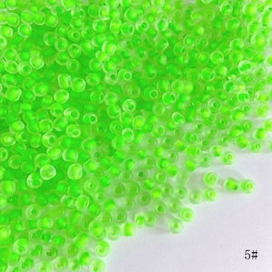 Macro shot of 4mm lime green matte seed beads with translucent finish for DIY jewelry