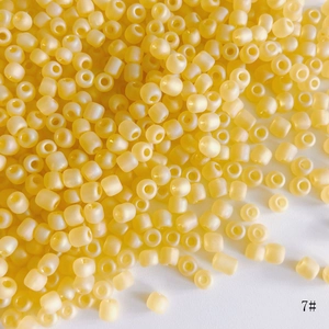 Macro shot of 4mm yellow frosted glass seed beads for DIY handmade jewelry crafts