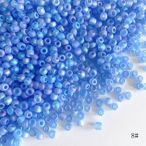 Macro shot of 4mm frosted blue AB rainbow glass seed beads for DIY jewelry making