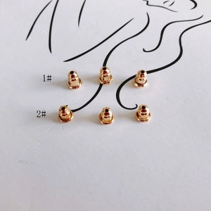 Golden DIY jewelry accessories with two types of earring backs on artistic background