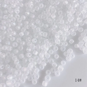 Macro shot of 4mm frosted white seed beads with a soft matte finish for DIY jewelry