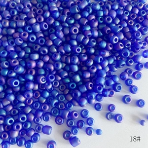 Macro shot of 4mm blue-purple frosted glass seed beads with AB rainbow finish for DIY jewelry