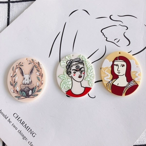 Three acrylic round charms featuring cartoon rabbit and art portrait relief designs