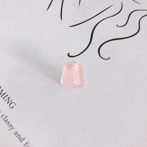 Close-up of pink translucent trapezoid resin earrings with subtle glitter and 925 silver pins