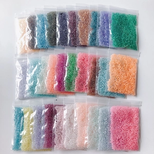 Macro shot of 2mm cream glass seed beads in multiple colors for DIY jewelry making