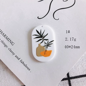 Detail of 40x24mm oval acrylic rabbit pendant with Nordic plant print for DIY jewelry