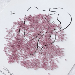 Macro shot of 2mm purple translucent glass beads on a minimalist artistic display card
