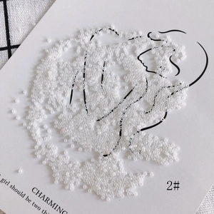 Macro shot of 2mm creamy white glass seed beads for DIY jewelry making and crafts