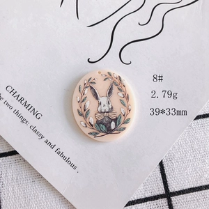 Detail view of 39x33mm bunny relief acrylic pendant with weights and dimensions shown
