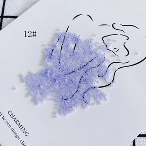 Artistic detail of 2mm purple cream glass seed beads for DIY jewelry making