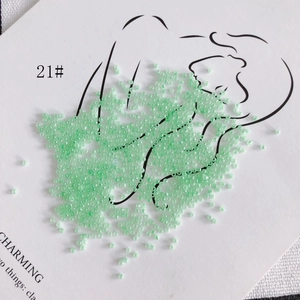 Artistic layout of 2mm light green glass seed beads on a minimalist illustration card
