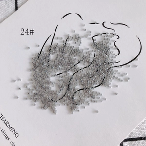 Macro shot of 2mm silver-grey seed beads for DIY jewelry with metallic luster finish
