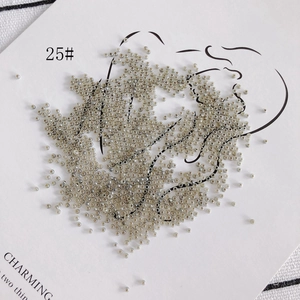 Macro view of 2mm cream jade glass seed beads in metallic grey for DIY jewelry making