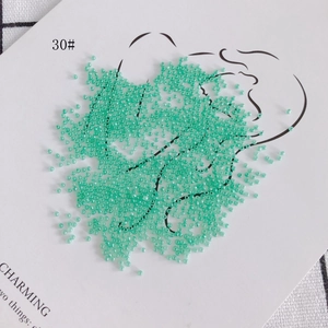Macro shot of 2mm translucent mint green glass seed beads for DIY jewelry making
