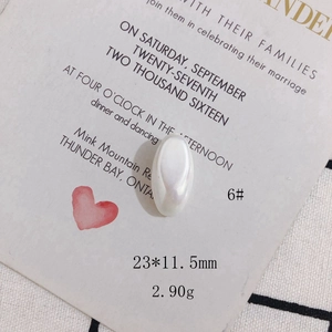Macro detail of 23x11.5mm creamy white shell-like cabochon bead for DIY jewelry