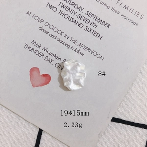 Macro detail of 19x15mm baroque style cream white shell-like resin accessory charm