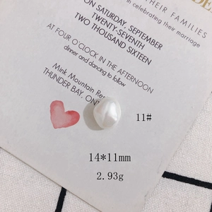 Macro detail of irregular creamy white baroque pearl bead showing 14x11mm size and texture