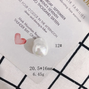 Macro view of cream white irregular baroque shell bead with dimensions 20.5x16mm