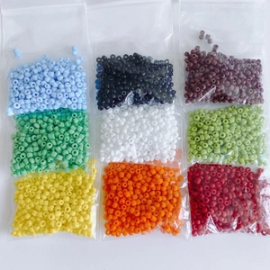 Nine colors of 3mm matte glass seed beads in small clear bags for DIY jewelry making