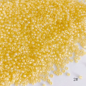 Macro shot of 2mm yellow frosted glass seed beads with internal hole for DIY jewelry