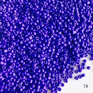 Close-up of 2mm matte purple glass seed beads for DIY jewelry making crafts