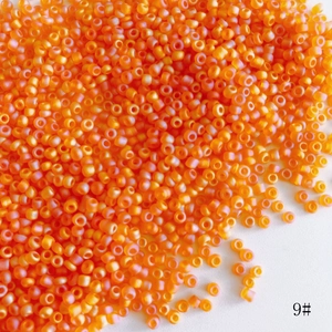 Macro shot of 2mm orange frosted glass seed beads for DIY jewelry making material
