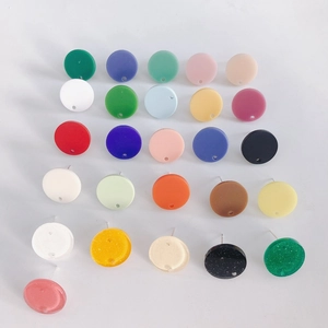 Macro view of colorful round acrylic earring studs and DIY jewelry components