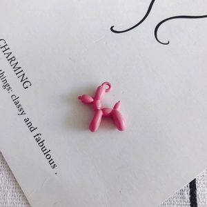 Close-up of pink balloon dog pendant charm with glossy finish for DIY jewelry crafting