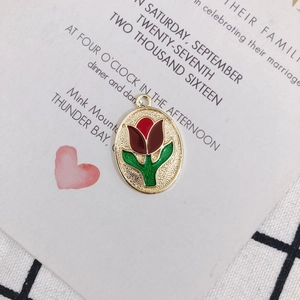 Detail of vintage tulip pendant with red enamel inlay and gold alloy frame