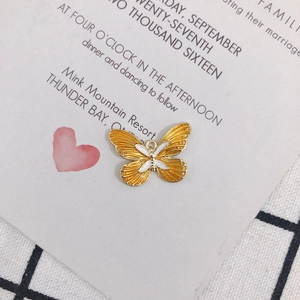 Detail of DIY butterfly charm with gold metal outline and yellow enamel inlay