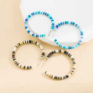 Close-up of Bohemian C-shaped earrings with colorful handmade clay heishi beads