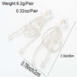 Detailed view of long tassel earrings with white pearls and heart-shaped beads measuring 8cm