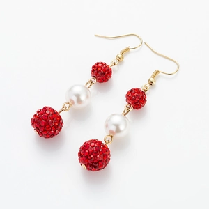 Detail of cherry-style red rhinestone drop earrings with white pearls and gold hooks