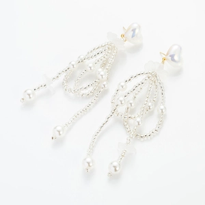 Detail of white pearl fringe earrings with iridescent heart studs and glass beads