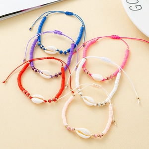 Detail of 6 colorful bohemian shell bracelets with clay beads and adjustable cords