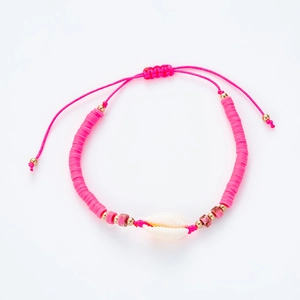Detail of pink bohemian bracelet with shell charm and adjustable braided cord