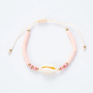 Bohemian adjustable shell bracelet with pink clay discs and gold beads on white background