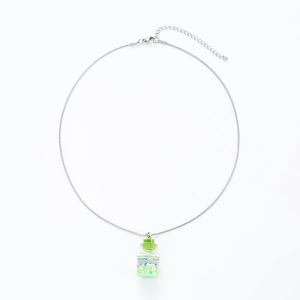 Detail of silver snake chain with green glass wishing bottle pendant and star sequins