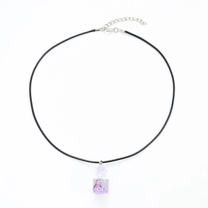 Detailed view of creative message bottle necklace with purple glitter and star sequins