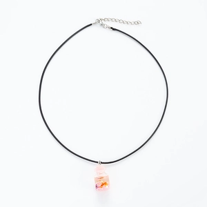Pink driftwood bottle necklace with colorful star sequins on a black cord