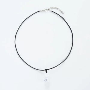 Detail of transparent bear pendant on black woven cord necklace with adjustable clasp
