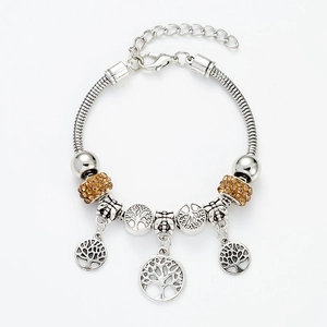 Detailed macro view of silver snake chain bracelet featuring tree of life charms and crystals