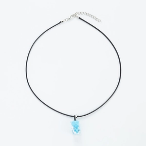 Close-up of translucent light blue gummy bear pendant with black adjustable cord