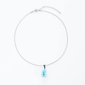 Detailed close-up of a light blue resin bear pendant on a silver stainless steel chain