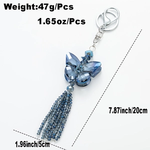 Blue crystal butterfly keychain with bead tassel and silver lobster clasp on white background