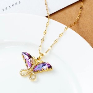 18K gold plated necklace with purple zircon butterfly pendant on a white porcelain dish