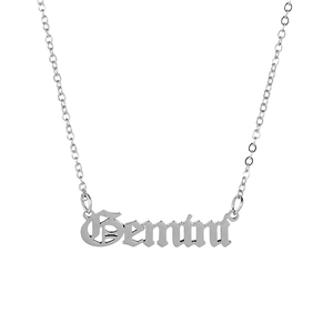 Macro shot of silver Gemini gothic pendant necklace with polished stainless steel chain