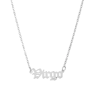 Macro detail of silver Virgo zodiac pendant necklace in gothic font with cross chain