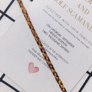 Detailed view of amber resin acrylic chain links on a stylish monochrome background